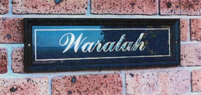 sample of black timber and glass nameplate